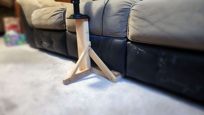 The wooden stand I designed and built to hold my laptop arm.
