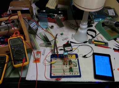The first working prototype of my VFD clock, wide angle.  Including messy project table!