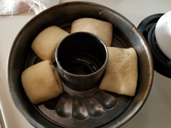 Dough has risen, is divided and rolled and set in (the wrong) pan.